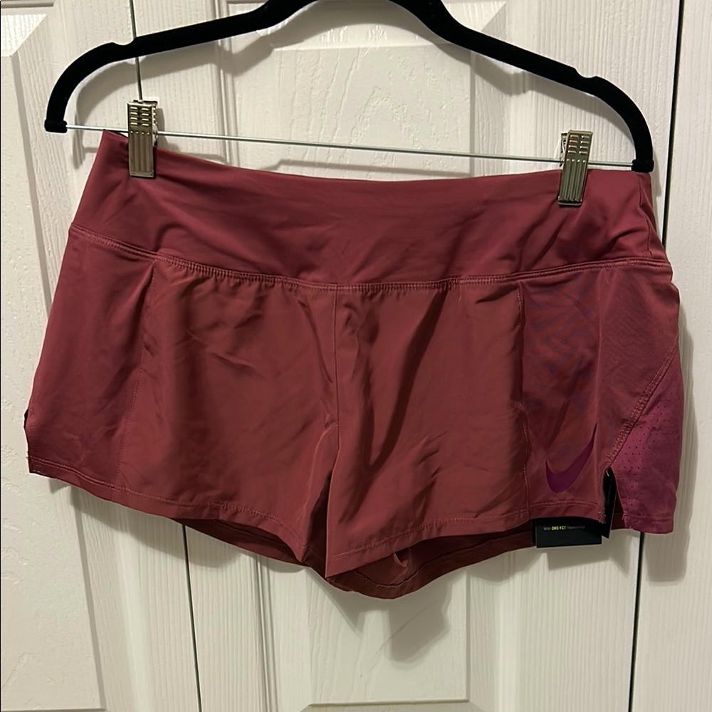 NWT Nike Women's Shorts. Size large. Muted burgundy. Just Do It on back waist